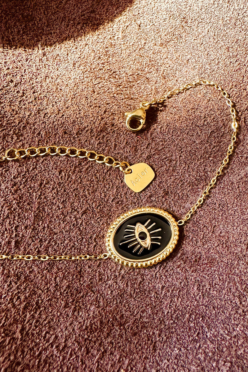 CORALIE | Pulsera de eslabones finos dorados con ojo negro