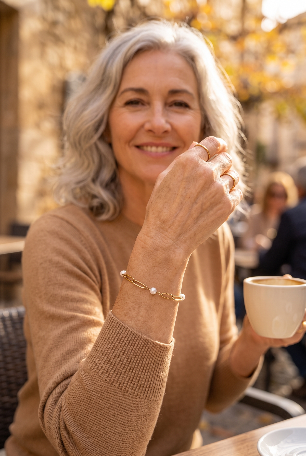 CHLOÉ — pulsera de cadena de eslabones dorados y perlas nacaradas blancas, en una terraza en otoño